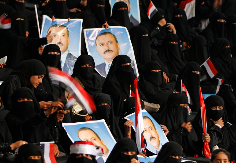 Image: Women supporters of Yemen's President Ali Abdullah Saleh hold his posters during a gathering in Sanaa
