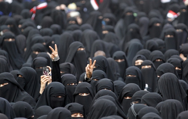 Image: Women flash the victory sign during a rally to demand the ouster of Yemen's President Ali Abdullah Saleh outside Sanaa University