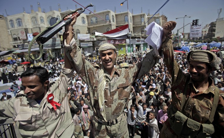 Image: Yemeni army officers react as they join anti-government protestors demanding the resignation of Yemeni President Ali Abdullah Saleh, in Sanaa,Yemen, Monday
