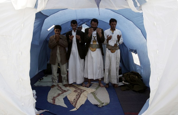 Image: Anti-government protesters perform prayers inside their tent during a sit-in to demand the ouster of Yemen's President Saleh in Sanaa