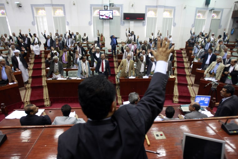 Image: Members of Yemen's parliament raise their hands as they vote in favour of the state of emergency declared by President Ali Abdullah Saleh last week in Sanaa