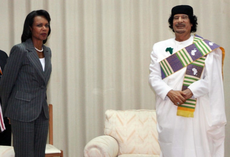Image: Libyan leader Moamer Kadhafi (R) poses w