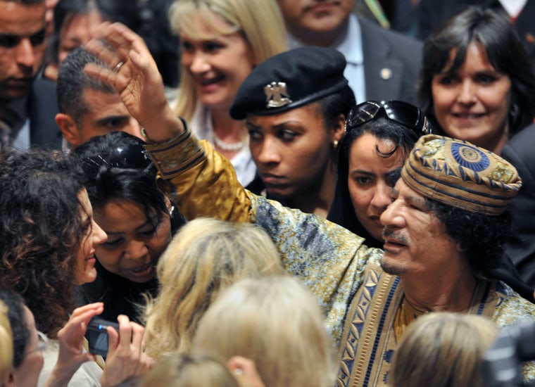 Image: Libyan leader Moamer Kadhafi (C) waves a