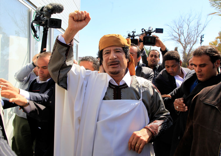 Image: Libyan leader Muammar Gaddafi waves in Tripoli before making a speech