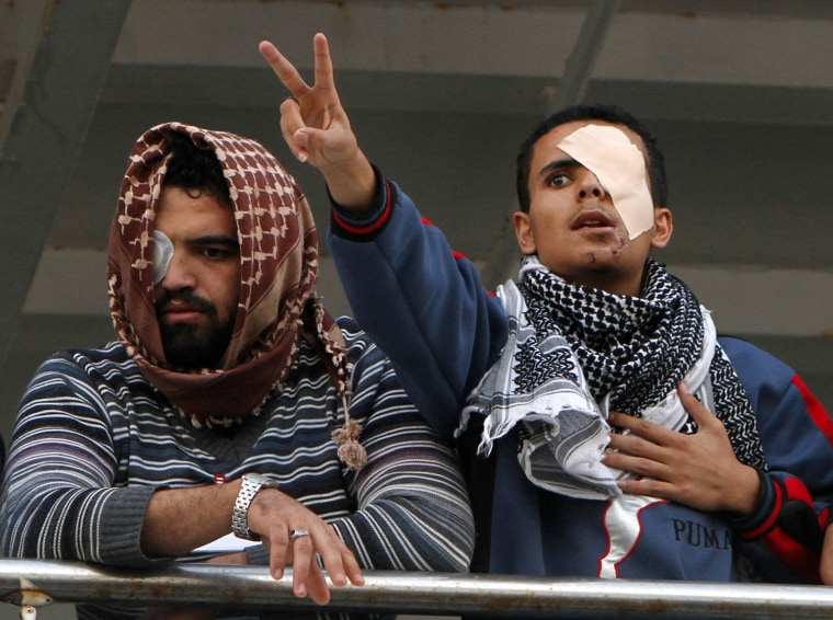 Image: Libyan men show the V-sign for victory a