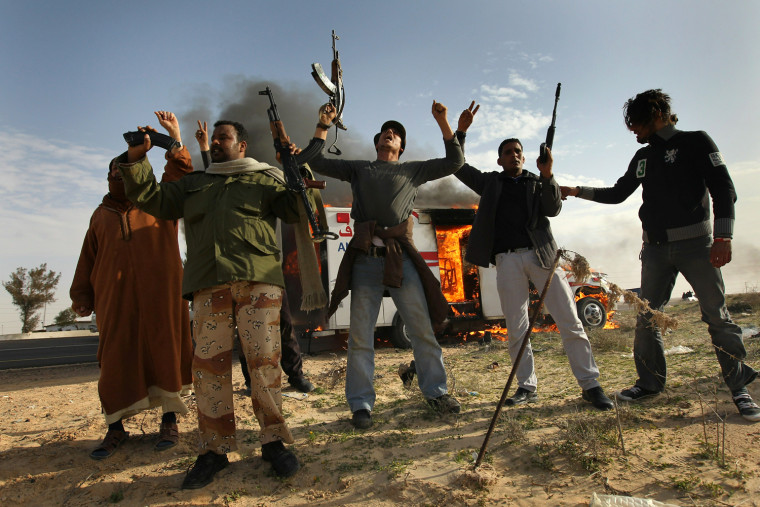 Rebel fighters celebrate after advancing front line against government fighters in Libya (©John Moore / Getty Images)