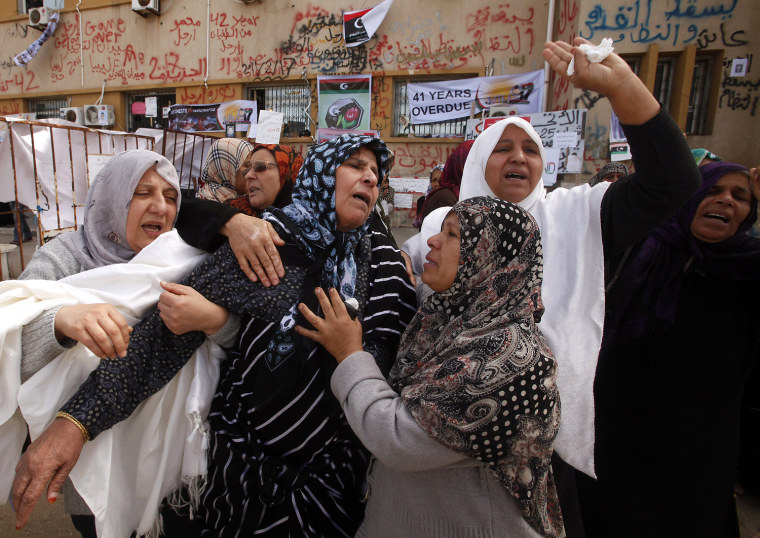 Image: Women mourn during funeral of people who were killed in weapons dump attack in Benghazi