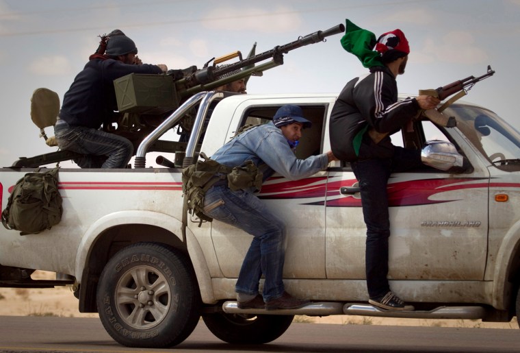 Image: Libyan rebels retreat as mortars from Moammar Gadhafi's forces are fired on them on the frontline of the outskirts of the city of Ajdabiya, south of Benghazi, eastern Libya, Tuesday, March 22.