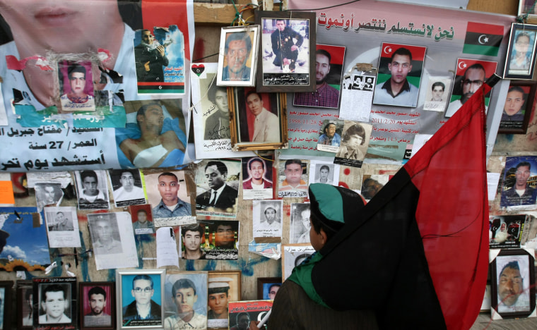 Image: A Libyan boy holding Libya's former nati