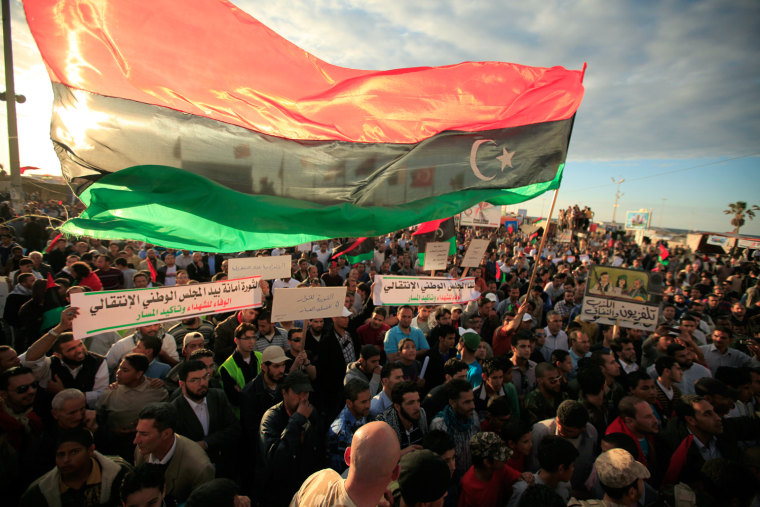 Image: Libyans attend a rally to support rebel fighters and Libyan National Council near the courthouse in Benghazi