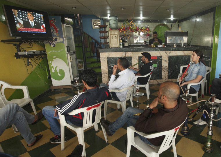 Image: Libyans watch a television broadcast of a speech by U.S. President Barack Obama in U.S., at a shop in Benghazi