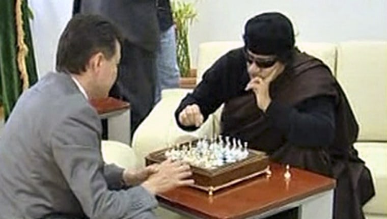 Libyan leader Moammar Gadhafi plays chess with Kirsan Ilyumzhinov, the president of the international chess federation, in Tripoli on June 12, 2011 in this image taken from video broadcast on Libyan state television. This was the last time he was seen before he was captured and killed.