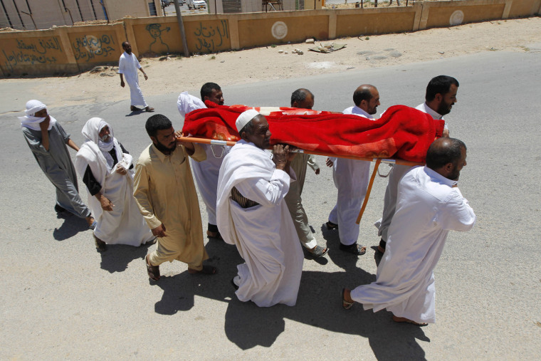 Image: Libyans carry the coffin of a rebel fighter killed during clashes with forces loyal to Muammar Gaddafi, on the outskirts of the western town of Riyayna