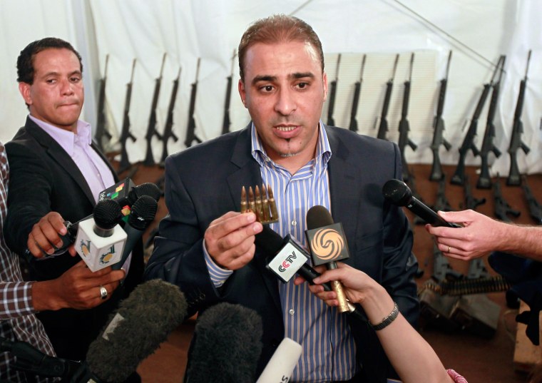 Libyan government spokesman Mussa Ibrahim speaks to journalists at the sea port in Tripoli on July 4, 2011. Ibrahim said Libya had arrested 11 rebels transporting about 100 light machine guns from Tunisia. The weapons had been supplied by Qatar, according to the spokesman. 

EDITOR'S NOTE: Picture taken on a government guided tour.