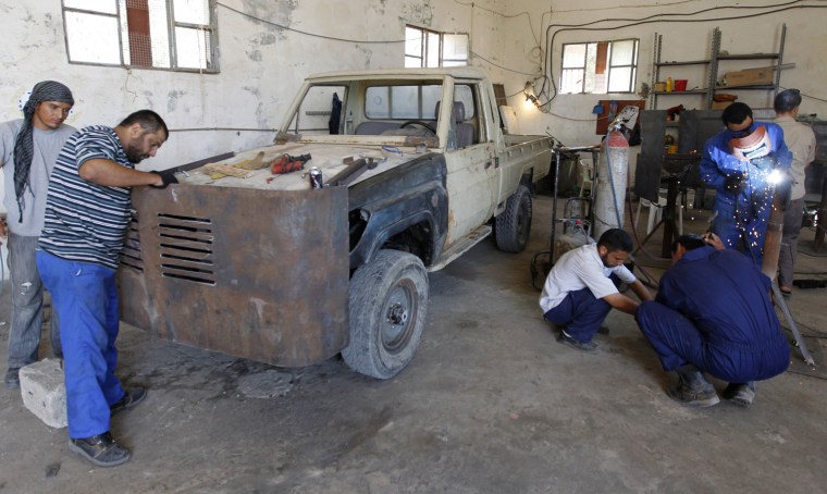 Libyan rebel mechanics weld metal plates to a truck in Misrata, July 10, 2011.