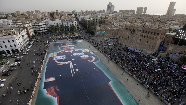 Image: A giant image of Libyan leader Muammar Gaddafi  is unveiled at the Green Square in central Tripoli