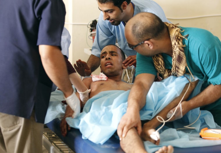 Image: IMC medics treat an injured member of forces loyal to Libyan leader Muammar Gaddafi who was taken prisoner, at a field hospital near Misrata