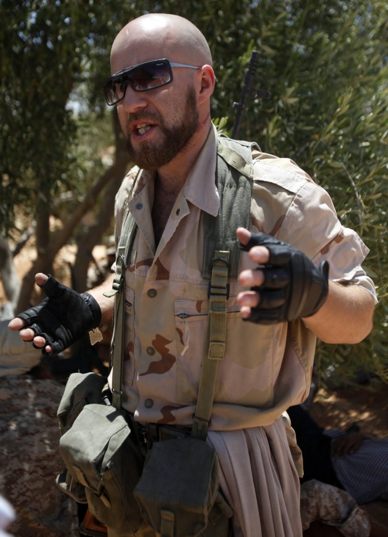 Image: Irish-Libyan rebel fighter Najjair speaks to reporters at a front line checkpoint near Tiji