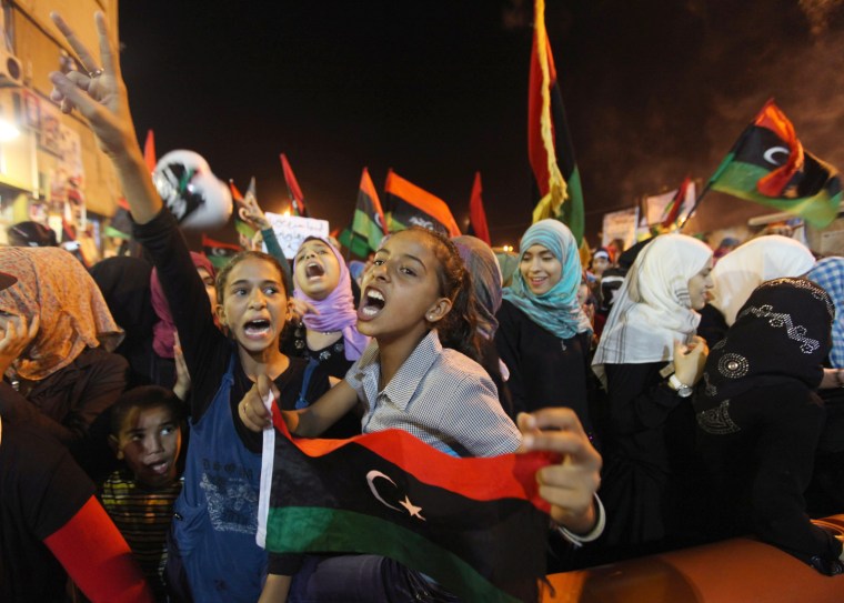 Image: Libyan people celebrate near a court house in Benghazi