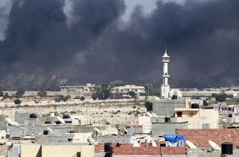 Image: Smoke rises above downtown Tripoli following fighting at Bab Al-Aziziya compound