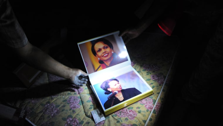 Young rebels show on of the many photo albums of former Secretary of State Condoleeza Rice, who obviously was on Gadhafi's mind, which were found in his residence 'Bab Al Aziziya', August 24, 2011, in Tripoli.