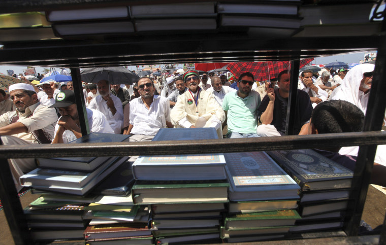 Image: Libyans attend Friday prayers near the court house in Benghazi