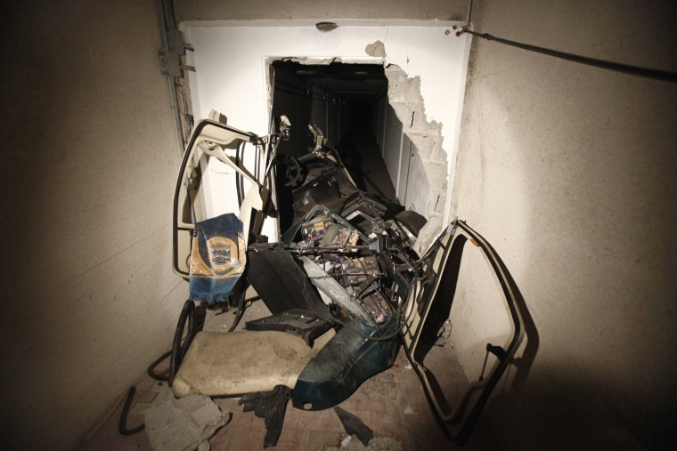 Image: A golf buggy belonging to Muammar Gaddafi is seen at a tunnel in the ransacked Bab al-Aziziya compound in Tripoli