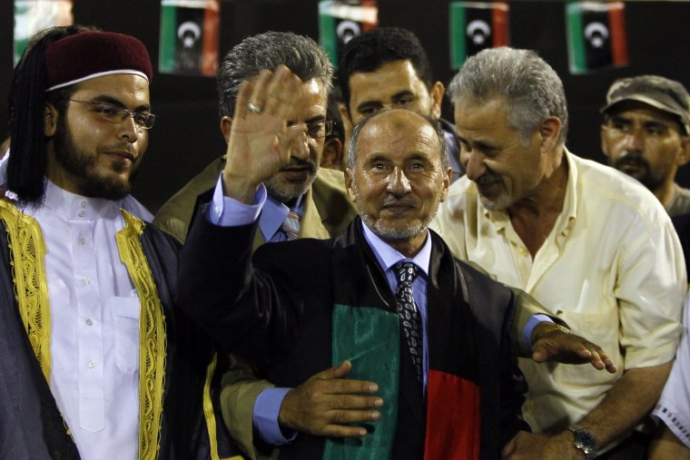 Libyan Transitional National Council chairman Mustafa Abdel Jalil waves to supporters after his speech at the former Green Square, renamed Martyr's Square in Tripoli, Sept. 12, 2011. The chief of Libya's former rebels arrived in Tripoli, and was greeted by a boisterous red carpet ceremony meant to show he's taking charge of the interim government replacing the ousted regime of Moammar Gadhafi.
