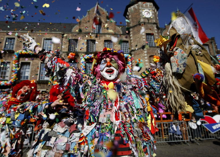 Image: A carnival reveller celebrates the traditional Rose Monday carnival parade in Duesseldorf