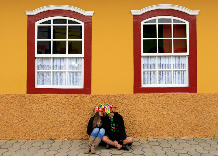 Image: Revellers kiss on a street during the Carnival of Sao Luis do Paraitinga