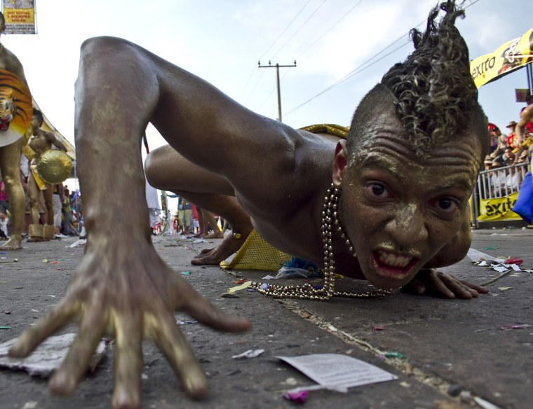 Image: A reveler performs during Carnival festi
