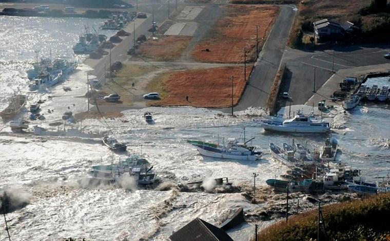 Image: Boats are swept by a wave after a tsunami and earthquake in Asahikawa city