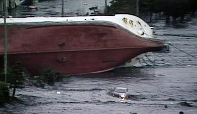 Image: Frame grab of an overturned boat following a tsunami in Hachinohe