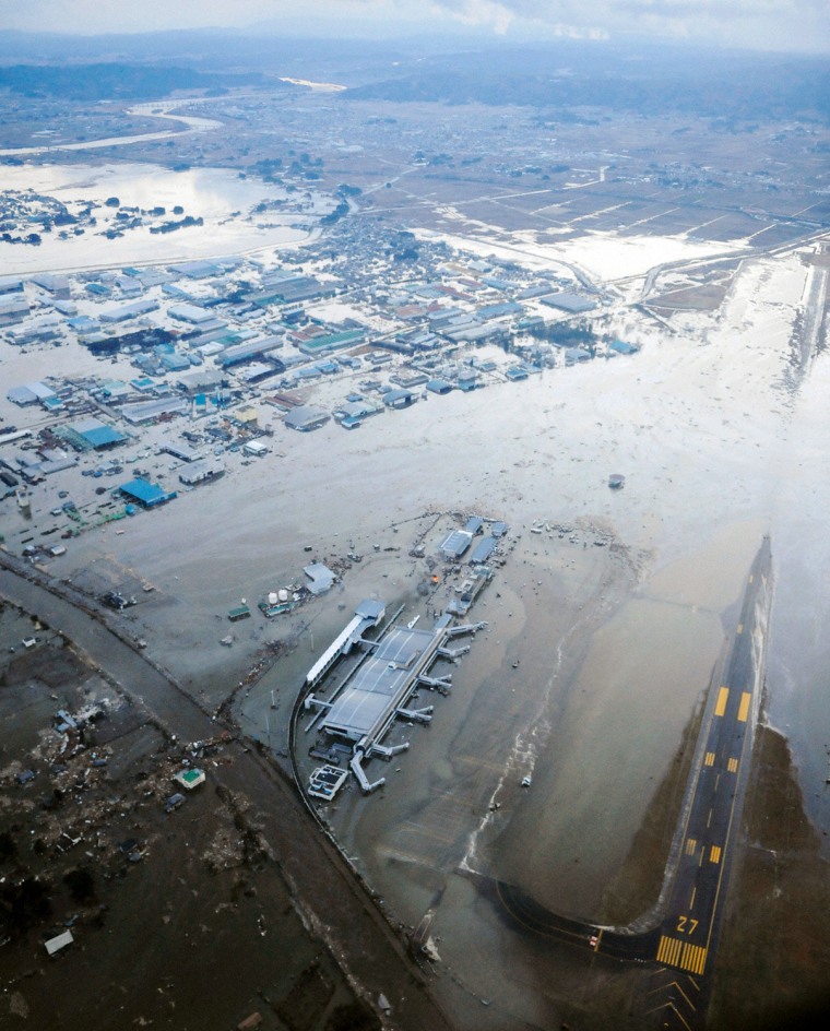 Image: An aerial view of a tsunami swamped Sendai Airport in northeastern Japan