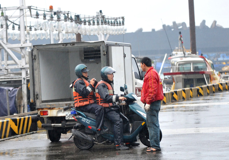 Image: Taiwanese coast guards instruct a fisher