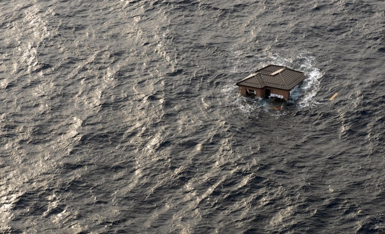 Image: A Japanese home is seen adrift in the Pacific Ocean