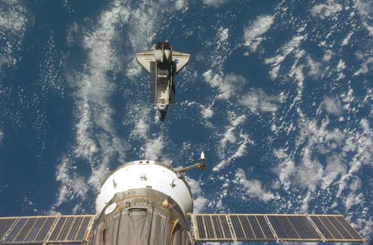 <HTML><META HTTP-EQUIV=\"content-type\" CONTENT=\"text/html;charset=utf-8\">

<H3>Flight Day 14</H3>
<P>Backdropped by Earth, space shuttle Endeavour is photographed by an 
Expedition 20 crew member onboard the International Space Station soon after the 
shuttle undocked from the station. A Soyuz spacecraft docked at the station is 
visible in the foreground.<BR><BR>Image credit: NASA <BR>July 28, 2009<BR></P>