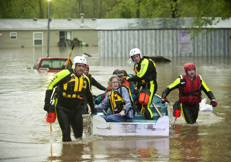 Image: Residents of Oak Glen Residential Community are assisted by rescue personell as rising waters from a nearby creek forced them to evacuate their homes on Monday, April 25, 2011, in Johnson, Ark.