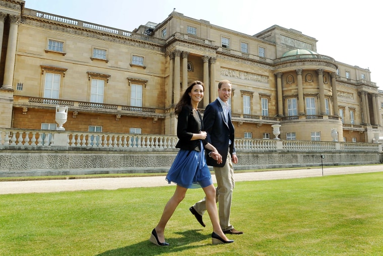 Image: Britain's Prince William and Catherine, Duchess of Cambridge, walk together in Buckingham Palace in central London