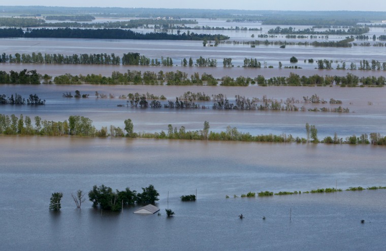 Image: A structure is seen nearly covered by floodwater from the Mississippi River,