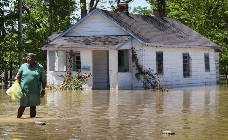 Image: James Strayhorn carries groceries through a flooded neighborhood back to his home May 4, 2011 in Tiptonville, Tennessee.