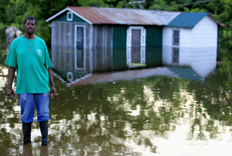 Image: Frank Rankin stands in front of his flooded home along Chickasaw Road, which has been surrounded by water from the swelling Mississippi River in Vicksburg, Mississippi