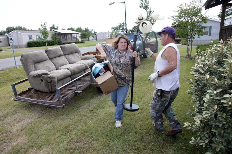 Image: April Bordelon helps her brother Justin Reech move a load of belongings