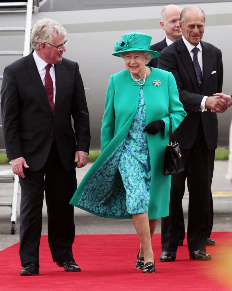 Image: Britain's Queen Elizabeth walks with the Tanaiste Eamon Gilmore on arrival at Baldonnel Aerodrome near Dublin
