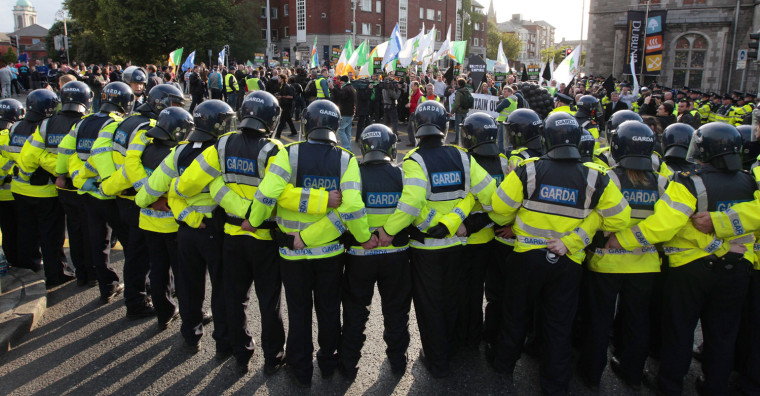 Image: Police block a road to protestors during a demonstration over the visit by Britian's Queen Elizabeth in Dublin