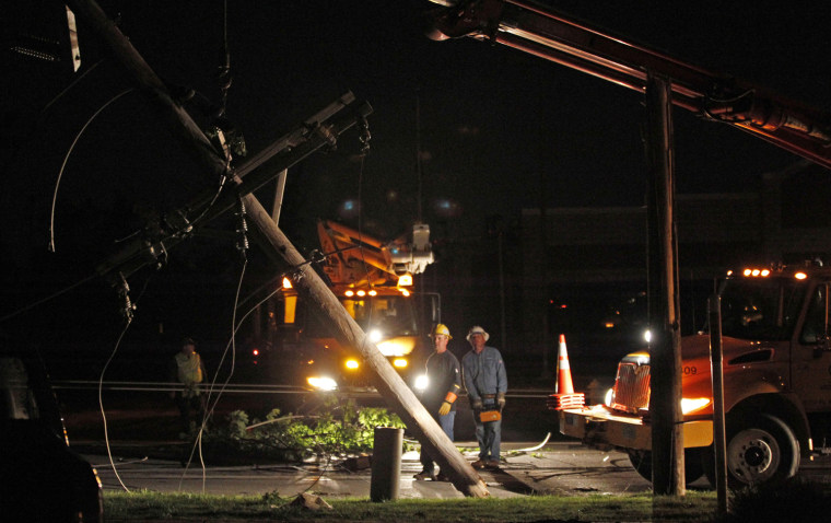 Image: Utility workers clear downed power lines after a devastating tornado hit Joplin