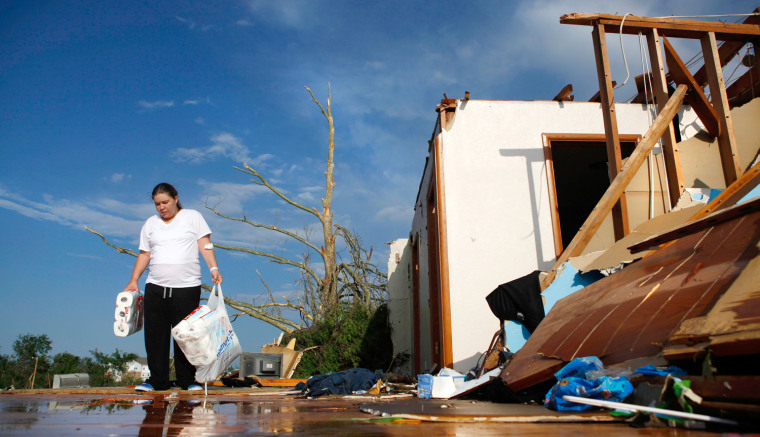 Image: Alicia Gordon salvages items from her home that was destroyed by a devastating tornado that hit Joplin