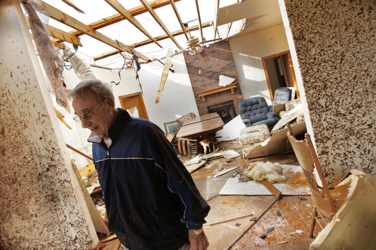 Image: Ken Haebaum stands in his mud-splattered kitchen after a tornado ripped through the Falcon Lake area of Piedmont