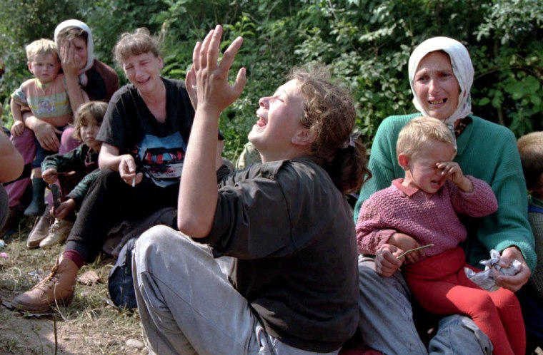 Image: File photo of Bosnian refugees from Srebrenica crying over their missing men in the refugee camp at the Tuzla airport