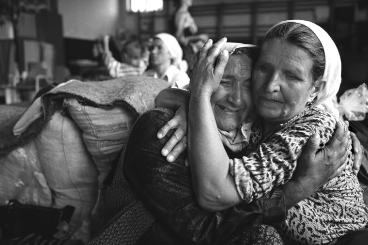 SREBRINICA, BOSNIA- JULY 1995: In July 1995 the worst case of genocide since World War II took place at Srebrinica in Bosnia.  Over a period of five day Bosnian Serb army took control of the small spa town and separated Muslim males from their families.  Over 7,000 men and boys were systematically murdered in the fields and valleys around the area.   Grieving elderly Muslim women pictured in a refugee centre set up to shelter Muslim families after they fled Srebrinica. (Photo by Tom Stoddart/Getty Images)